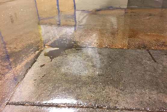 Moisture mitigation applied to a concrete slab